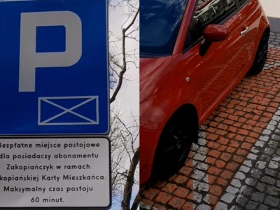 Pomarańczowe koperty na parkingach. 